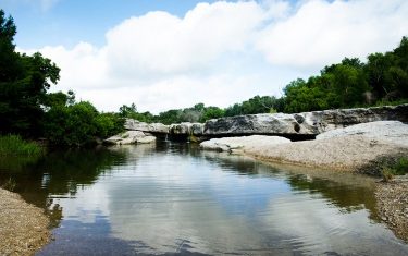 Jump Into McKinney Falls State Park’s Lower Falls To Beat The Heat