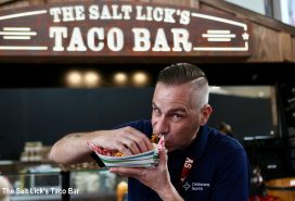 man eats taco from The Salt Lick's taco bar at Austin-Bergstrom International Airport