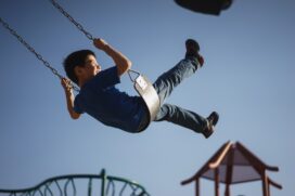 boy swinging at a playground
